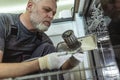 Male Technician Repairing Dishwasher In Kitchen Royalty Free Stock Photo