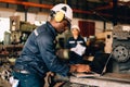 Male technician specialist with safety uniform using laptop checking machinery