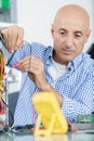 male technician using voltage meter Royalty Free Stock Photo