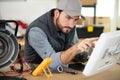 male technician using voltage meter and pc Royalty Free Stock Photo