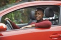 Male Teenage Driver Looking Out Of Car Window