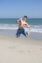 Male Teenager Jumping On Beach