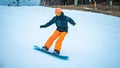 Male teenager taking a turn with his snowboard