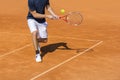 Male tennis player in action on the clay court Royalty Free Stock Photo