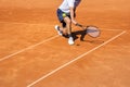 Male tennis player in action on the clay court Royalty Free Stock Photo