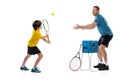 Male tennis player, coach training with teen to play tennis isolated over white studio background. Concept of sport Royalty Free Stock Photo