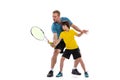 Male tennis player, coach training with teen to play tennis isolated over white studio background. Concept of sport Royalty Free Stock Photo