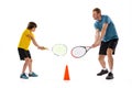 Male tennis player, coach training with teen to play tennis isolated over white studio background. Concept of sport Royalty Free Stock Photo