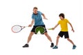 Male tennis player, coach training with teen to play tennis isolated over white studio background. Concept of sport Royalty Free Stock Photo