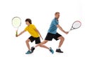 Male tennis player, coach training with teen to play tennis isolated over white studio background. Concept of sport Royalty Free Stock Photo