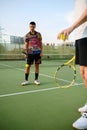 Male tennis players with rackets hits the balls Royalty Free Stock Photo