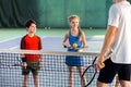 Male tennis trainer teaching children Royalty Free Stock Photo