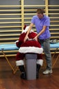male therapist massaging overworked Santa Claus