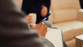 Male therapist taking notes on papers at psychology session Royalty Free Stock Photo