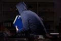 Male thief in balaclava in the office night time Royalty Free Stock Photo
