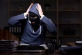 Male thief in balaclava in the office night time Royalty Free Stock Photo