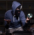 Male thief in balaclava in the office night time Royalty Free Stock Photo