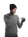 Male thief with flashlight and dollar banknote on white background