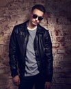 Male thinking model posing in leather jacket and trendy eyeglass Royalty Free Stock Photo