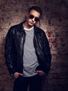 Male thinking model posing in leather jacket and trendy eyeglass Royalty Free Stock Photo