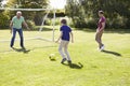 Male Three Generation Family Playing Football Together