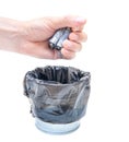 Male tossing dead corroded batteries in a regular garbage bin Royalty Free Stock Photo