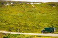 Male tourist at camper van in mountains