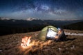 Male tourist enjoying in his camp at night. Man with a headlamp under beautiful sky full of stars and milky way Royalty Free Stock Photo