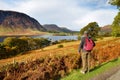 Male tourist enjoying the view of Crummock Water lake, located between Loweswater and Buttermere, in the Lake District in Cumbria Royalty Free Stock Photo