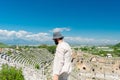 A male tourist enjoys a walk through the amphitheater among the ruins of the ancient city of Perge, in Turkey.