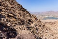 Male tourist hiking on a Hatta mountain sign hike trail in Hatta, Hajar Mountains.