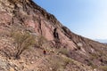 Male tourist hiking on rocky trail in Hatta, Hajar Mountains, United Arab Emirates.