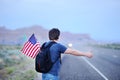 Male tourist hitchhiking along a desolate road Royalty Free Stock Photo