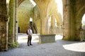Male tourist in Jerpoint Abbey, a ruined Cistercian abbey, located near Thomastown, County Kilkenny, Ireland Royalty Free Stock Photo