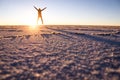 Male tourist jumping at sunrise - Salar de Uyuni, Bolivia