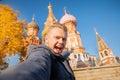 Male tourist makes selfie photo on background Saint Basil Cathedral Red Square in Moscow, Russia autumn. Travel concept Royalty Free Stock Photo