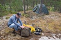 Male tourist making a camp at the forest Royalty Free Stock Photo