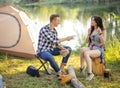 Male tourist is offering tea to a pleasant girl with long black hair Royalty Free Stock Photo