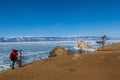 Male tourist is shooting a photo of Shaman rock at Olkhon island