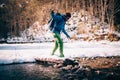 Male tourist ÃÂrosses a river in the mountains.