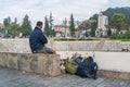 Male tourist sitting alone seeing scene in Sapa tourism town, Lao Cai, northern Vietnam