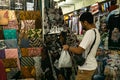 Male tourist sorting and selecting kain batik at Pasar Beringharjo Malioboro as souvenir from Yogyakarta at seller's window.