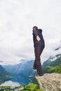 Male tourist standing on the cliff edge near Flydalsjuvet Viewpoint. Travel Norway Royalty Free Stock Photo