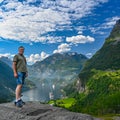 Male tourist standing high near Giranger in Norway Royalty Free Stock Photo