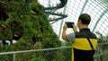 Male tourist take photo of cloud forest, Gardens by the Bay in Singapore