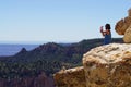 Male tourist taking a photo from Bright Angel Point, South rim, Grand Canyon focus on pinnacle.