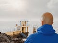 Male tourist taking picture on his smart phone of Blackrock, Galway, Ireland, Selective focus, Concept travel, capture and share Royalty Free Stock Photo