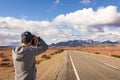 Male tourist taking pictures of the mountains at Ikara Flinders Ranges National Park. Panorama road heading to the ranges. Man Royalty Free Stock Photo