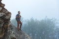 Male tourist on top of mountain in fog in autumn Royalty Free Stock Photo