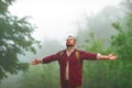 Male tourist on top of mountain in fog in autumn Royalty Free Stock Photo